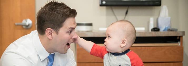 Chiropractor Maplewood MN Nicholas Okins with Little Baby Chiropractor Maplewood MN Nicholas Okins with Little Baby