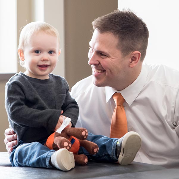 Chiropractor Maplewood MN Nicholas Okins With Baby