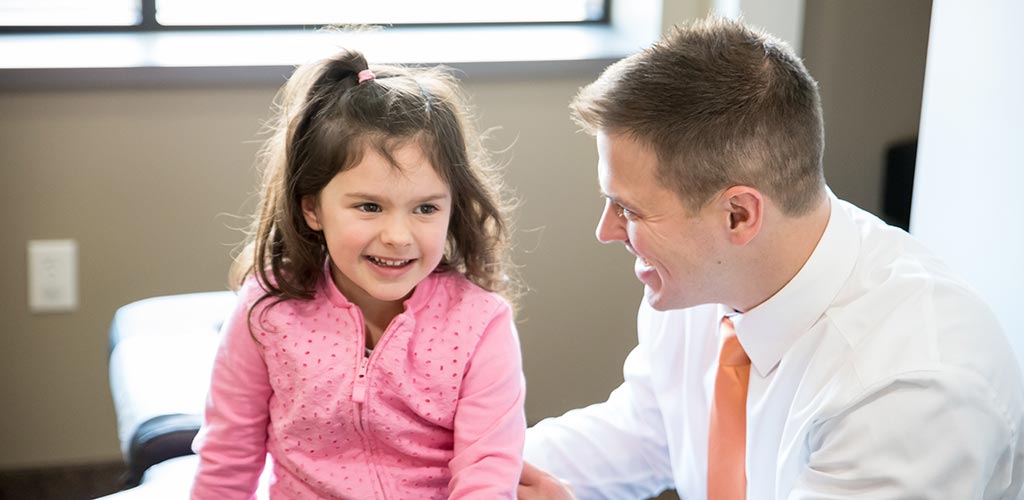 Chiropractor Nicholas Okins with Happy Child